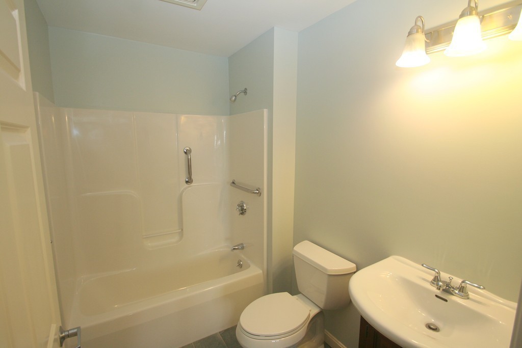 7 Assinippi Avenue, Unit 306 Norwell, MA 02061 - Photo 14 of 20 a white toilet sitting next to a bath tub