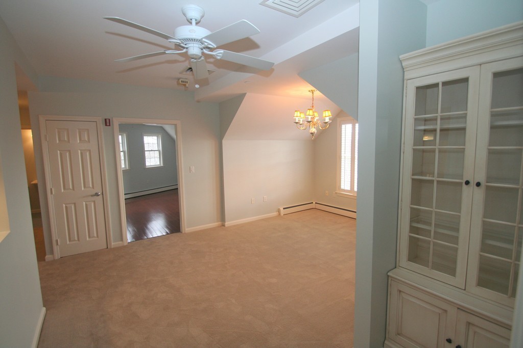 7 Assinippi Avenue, Unit 306 Norwell, MA 02061 - Photo 5 of 20 a view of a livingroom with a ceiling fan and window