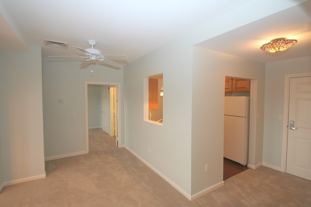7 Assinippi Avenue, Unit 306 Norwell, MA 02061 - Photo 6 of 20 a view of an empty room with a ceiling fan