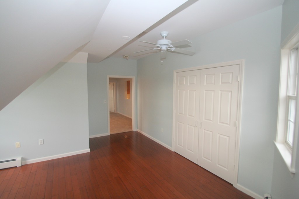 7 Assinippi Avenue, Unit 306 Norwell, MA 02061 - Photo 9 of 20 an empty room with windows and fan