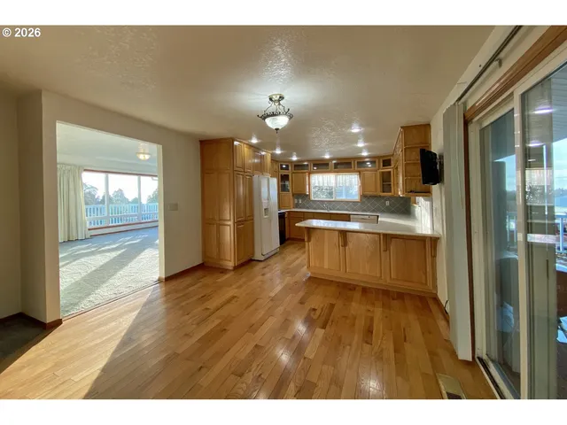 a view of a kitchen with a sink a refrigerator and window