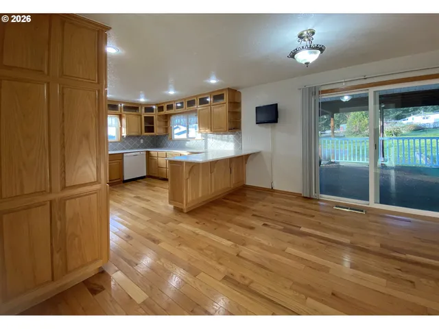a view of living room kitchen and entryway