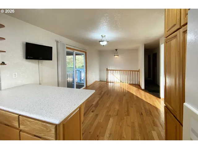 a view of kitchen with cabinets and wooden floor