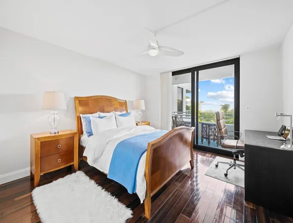 a bed room with a bed and a large window
