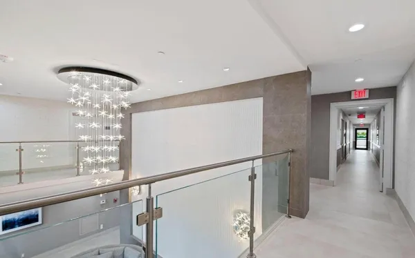 a view of a hallway with chandelier
