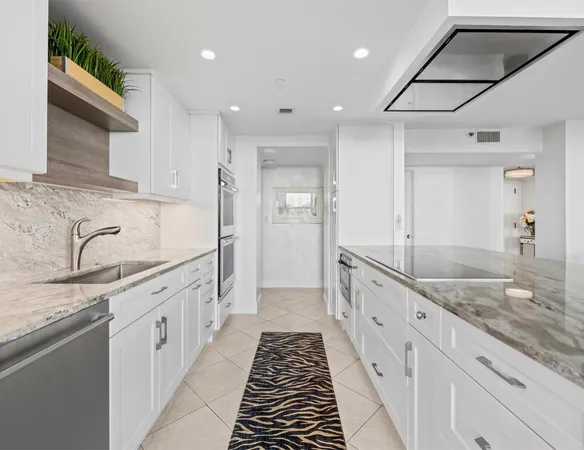 a large kitchen with granite countertop a sink and dishwasher stove top oven
