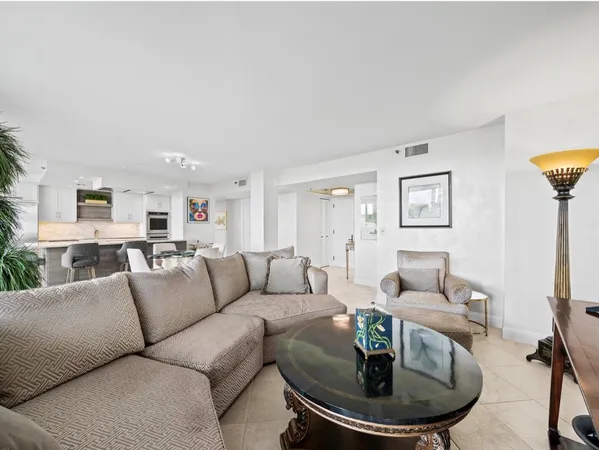 a living room with furniture a dining table and a fireplace