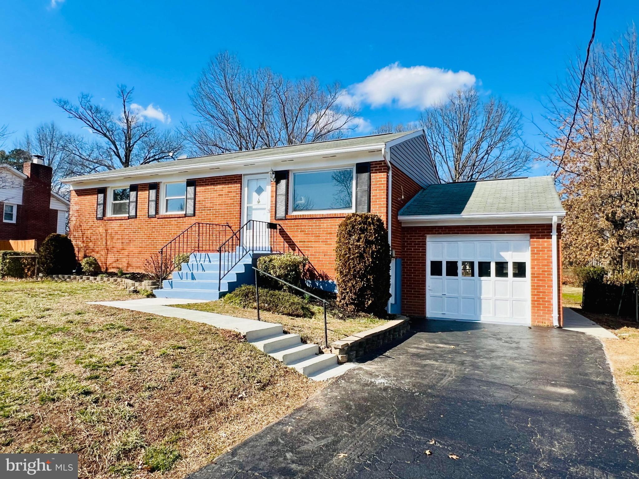 a view of a house with a yard covered in snow