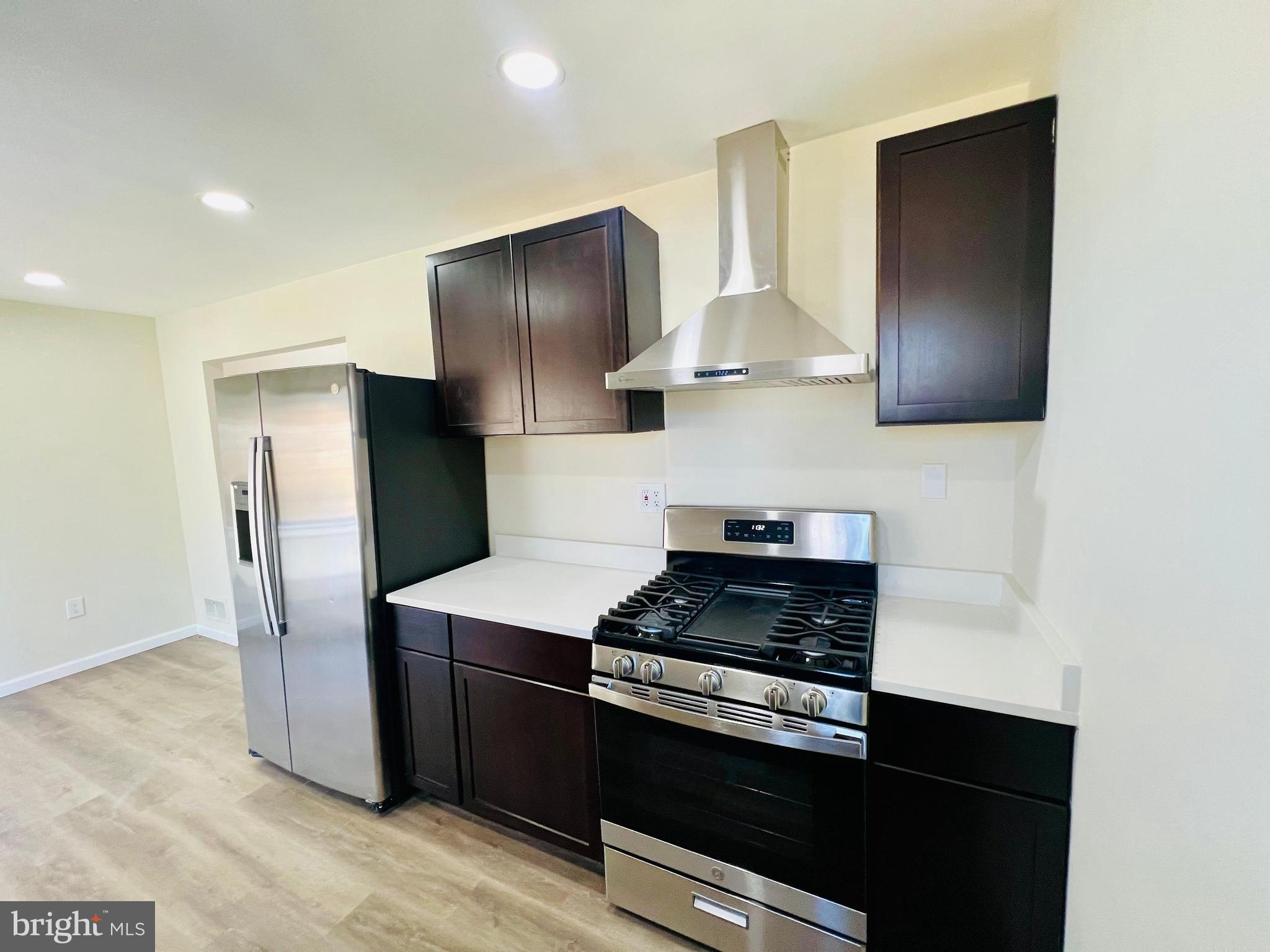 9826 Lomond Drive Manassas, VA 20109 - Photo 11 of 78 a kitchen with stainless steel appliances granite countertop a refrigerator and a stove