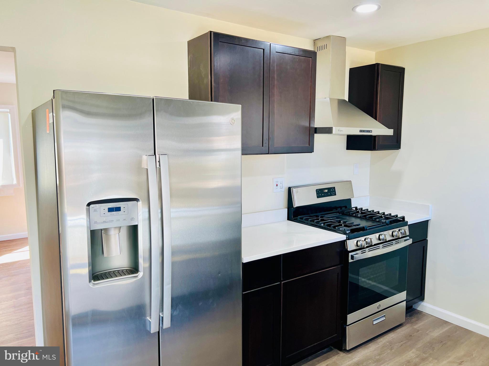 9826 Lomond Drive Manassas, VA 20109 - Photo 12 of 78 a kitchen with a refrigerator and a stove
