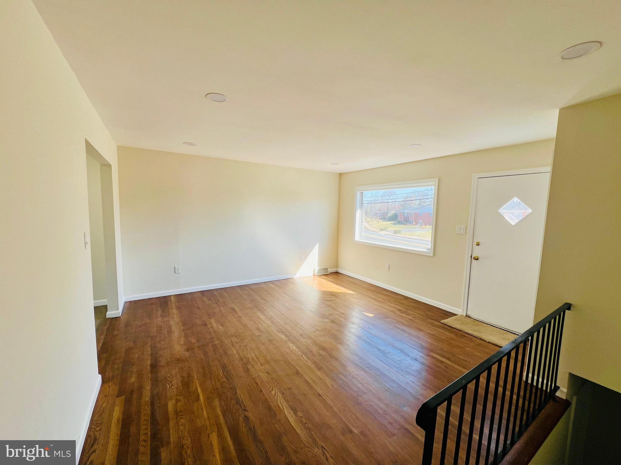9826 Lomond Drive Manassas, VA 20109 - Photo 19 of 78 a view of an empty room with wooden floor