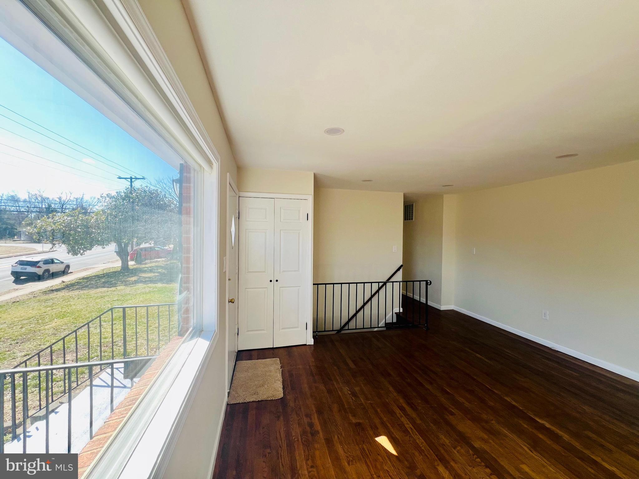 9826 Lomond Drive Manassas, VA 20109 - Photo 2 of 78 a view of a room with wooden floor and large windows