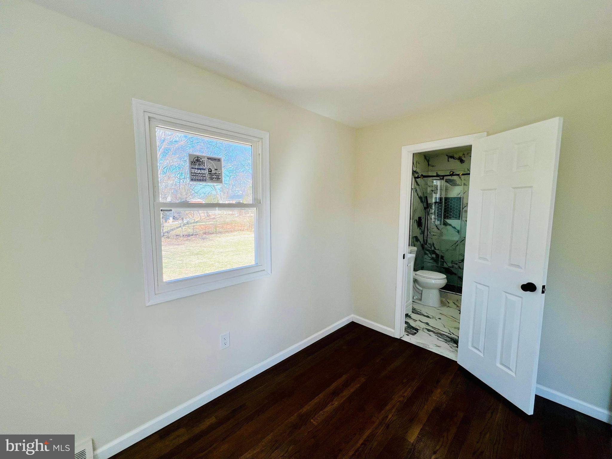 9826 Lomond Drive Manassas, VA 20109 - Photo 24 of 78 a view of an empty room with wooden floor and a window