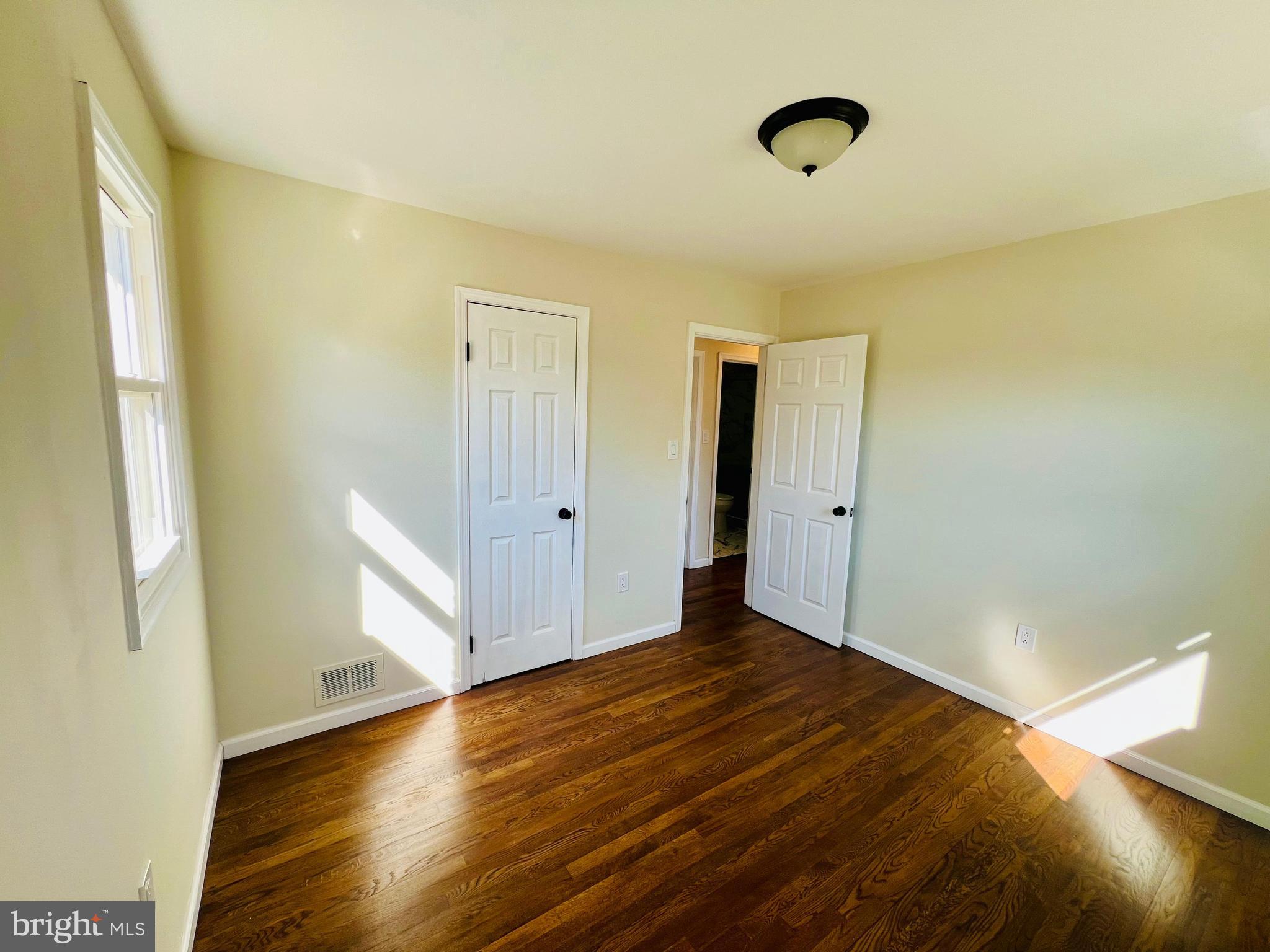 9826 Lomond Drive Manassas, VA 20109 - Photo 27 of 78 a view of an empty room with wooden floor and a window