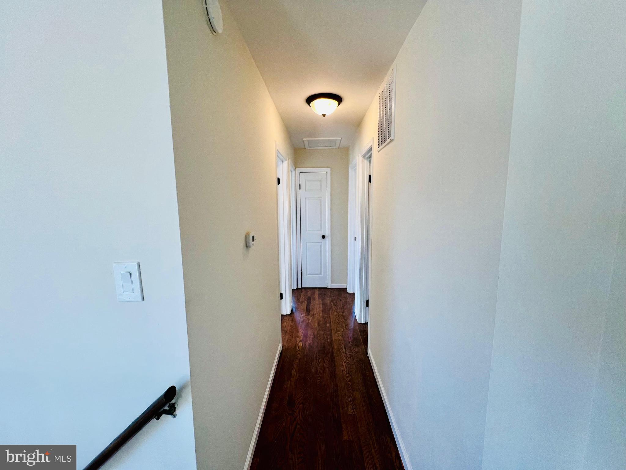 9826 Lomond Drive Manassas, VA 20109 - Photo 30 of 78 a view of a hallway with wooden floor and a glass door