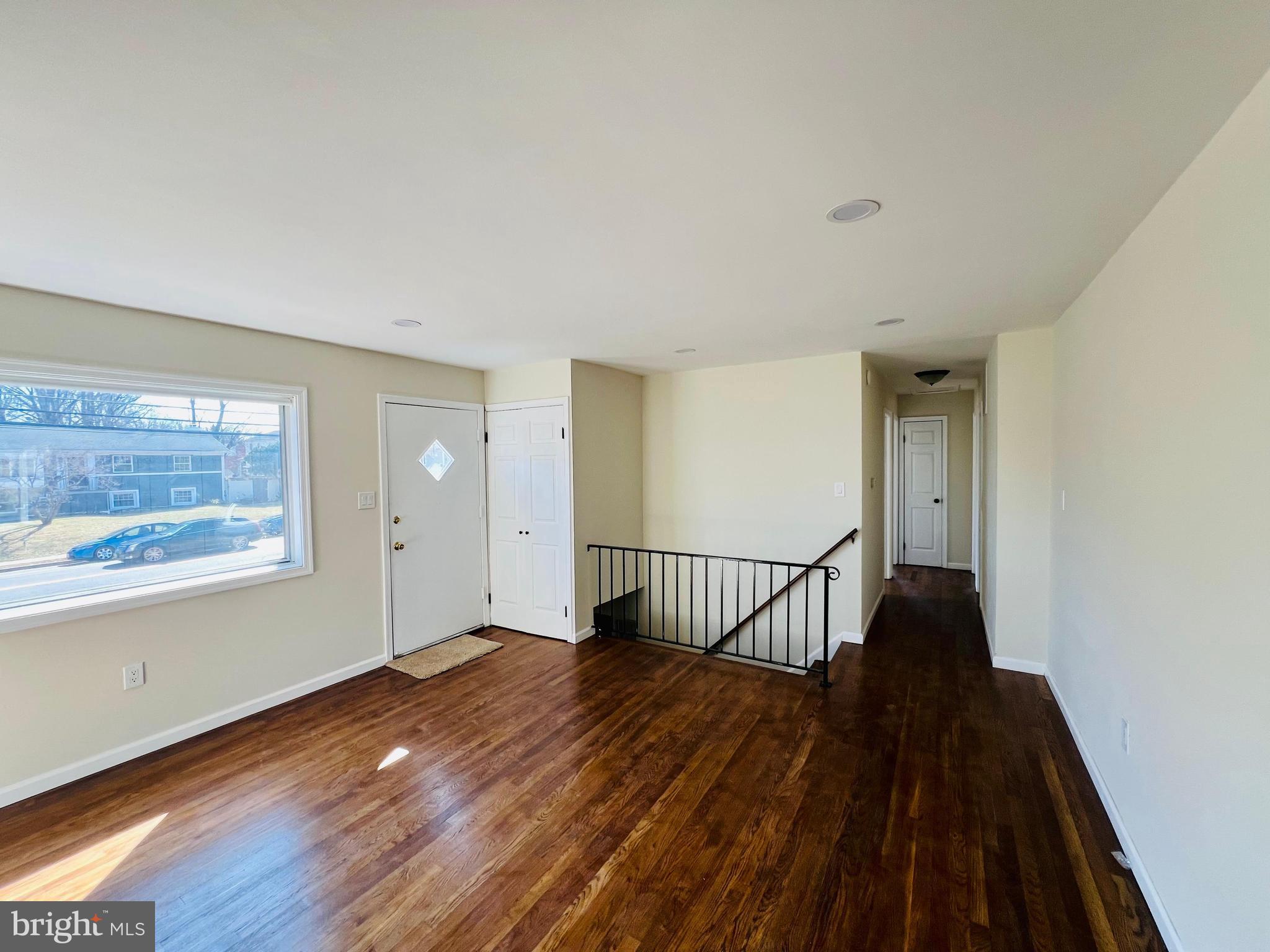 9826 Lomond Drive Manassas, VA 20109 - Photo 3 of 78 a view of a hallway with wooden floor and a floor to ceiling window