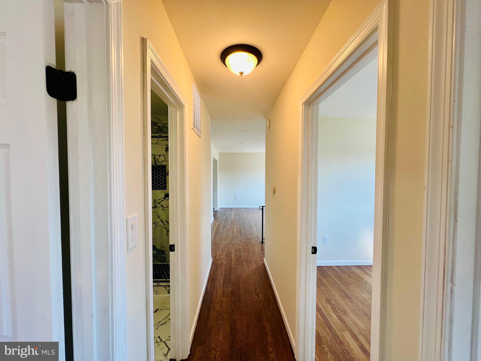 9826 Lomond Drive Manassas, VA 20109 - Photo 31 of 78 a view of a hallway with wooden floor and staircase