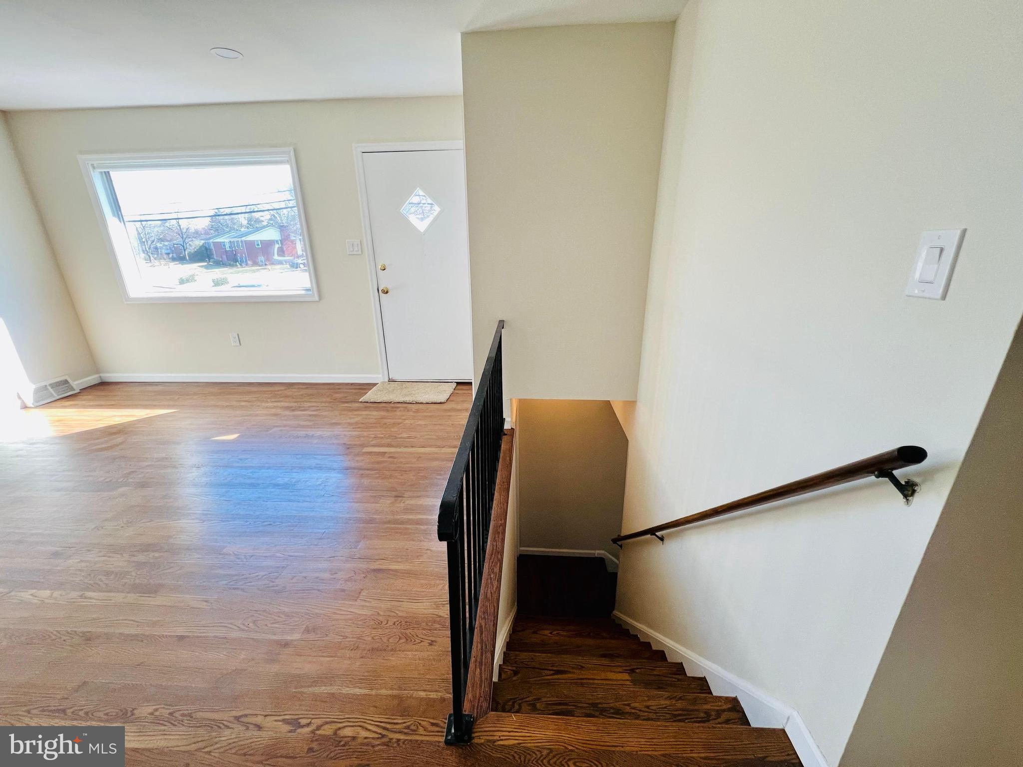 9826 Lomond Drive Manassas, VA 20109 - Photo 34 of 78 a view of a hallway with wooden floor and staircase