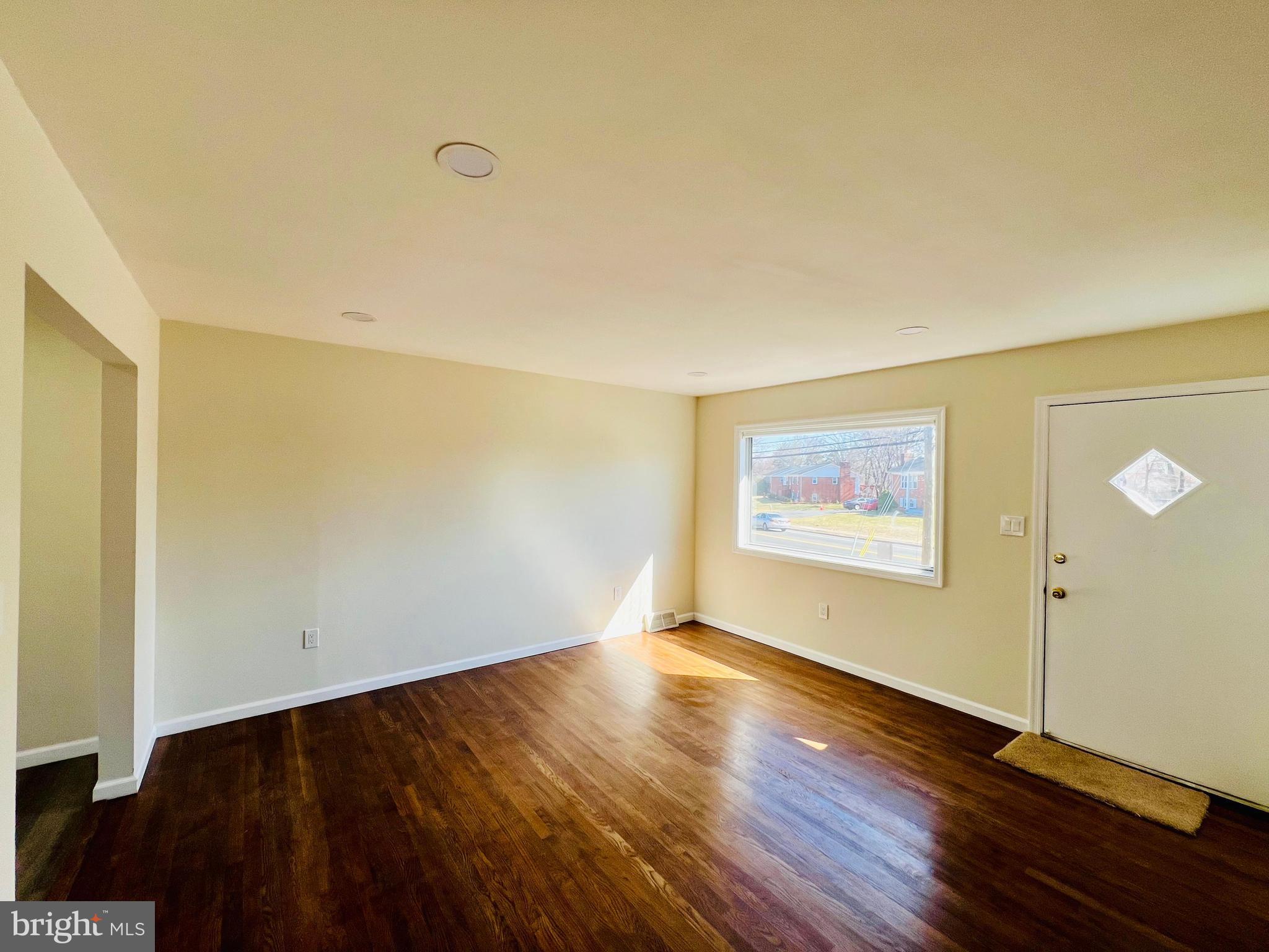 9826 Lomond Drive Manassas, VA 20109 - Photo 4 of 78 a view of an empty room with wooden floor
