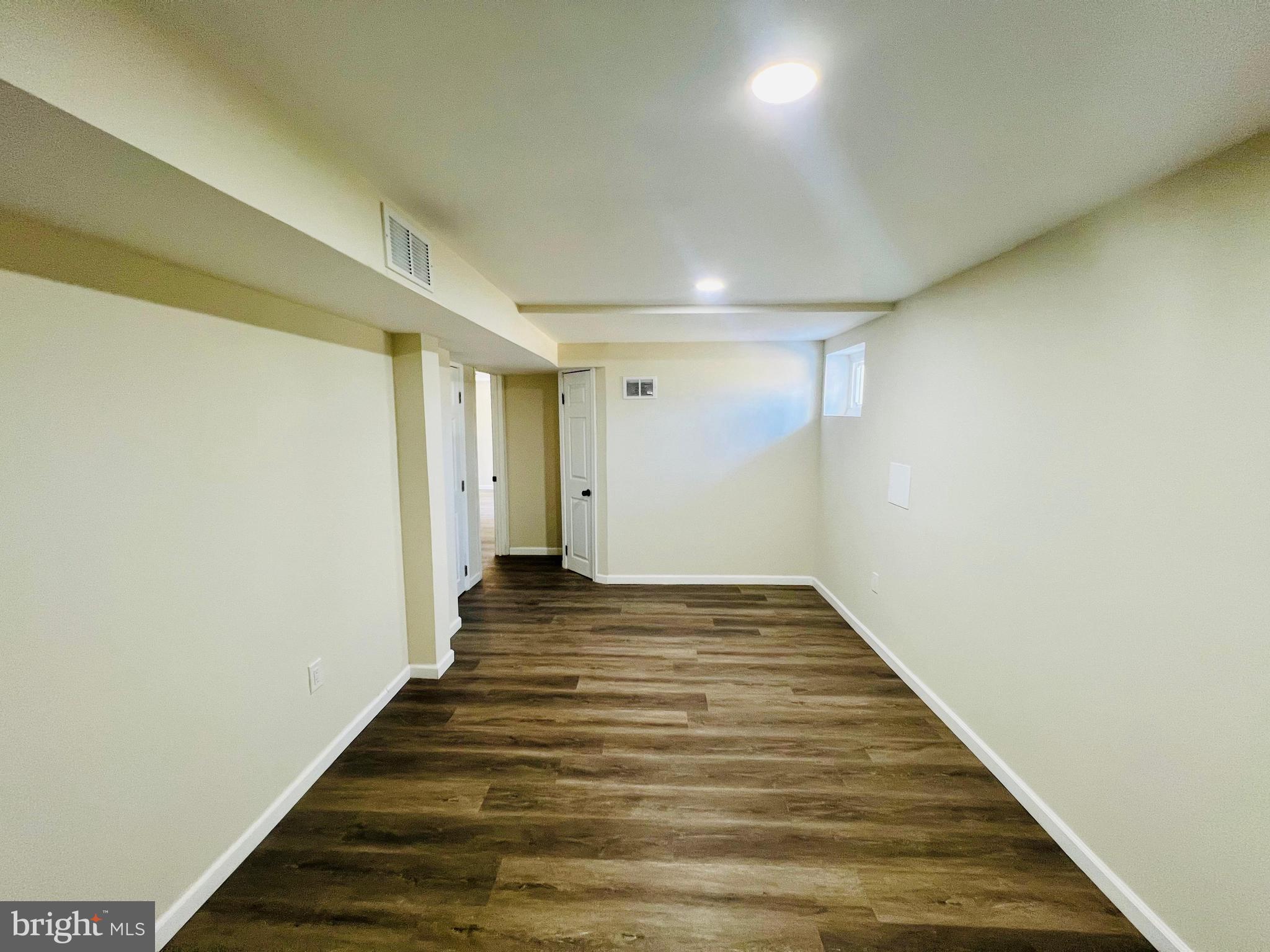9826 Lomond Drive Manassas, VA 20109 - Photo 43 of 78 a view of a hallway with wooden floor