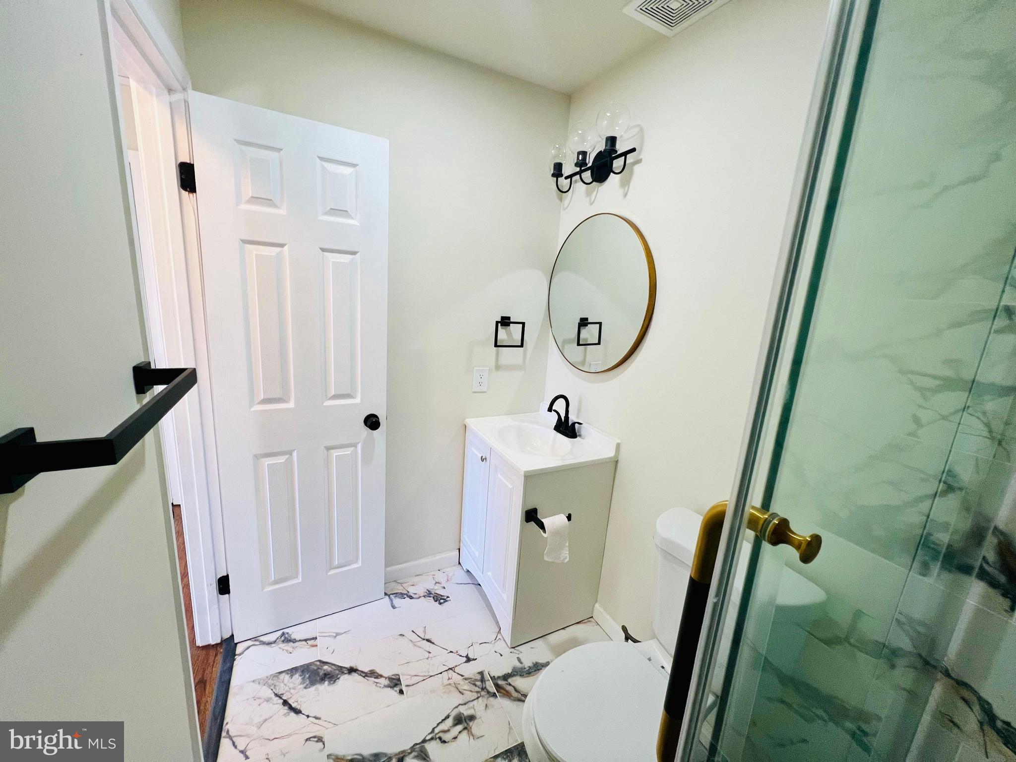 9826 Lomond Drive Manassas, VA 20109 - Photo 51 of 78 a bathroom with a sink and a mirror