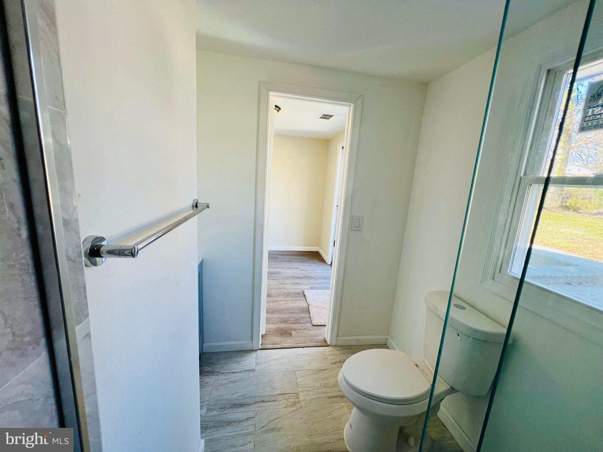 9826 Lomond Drive Manassas, VA 20109 - Photo 53 of 78 a bathroom with a granite countertop toilet and a sink