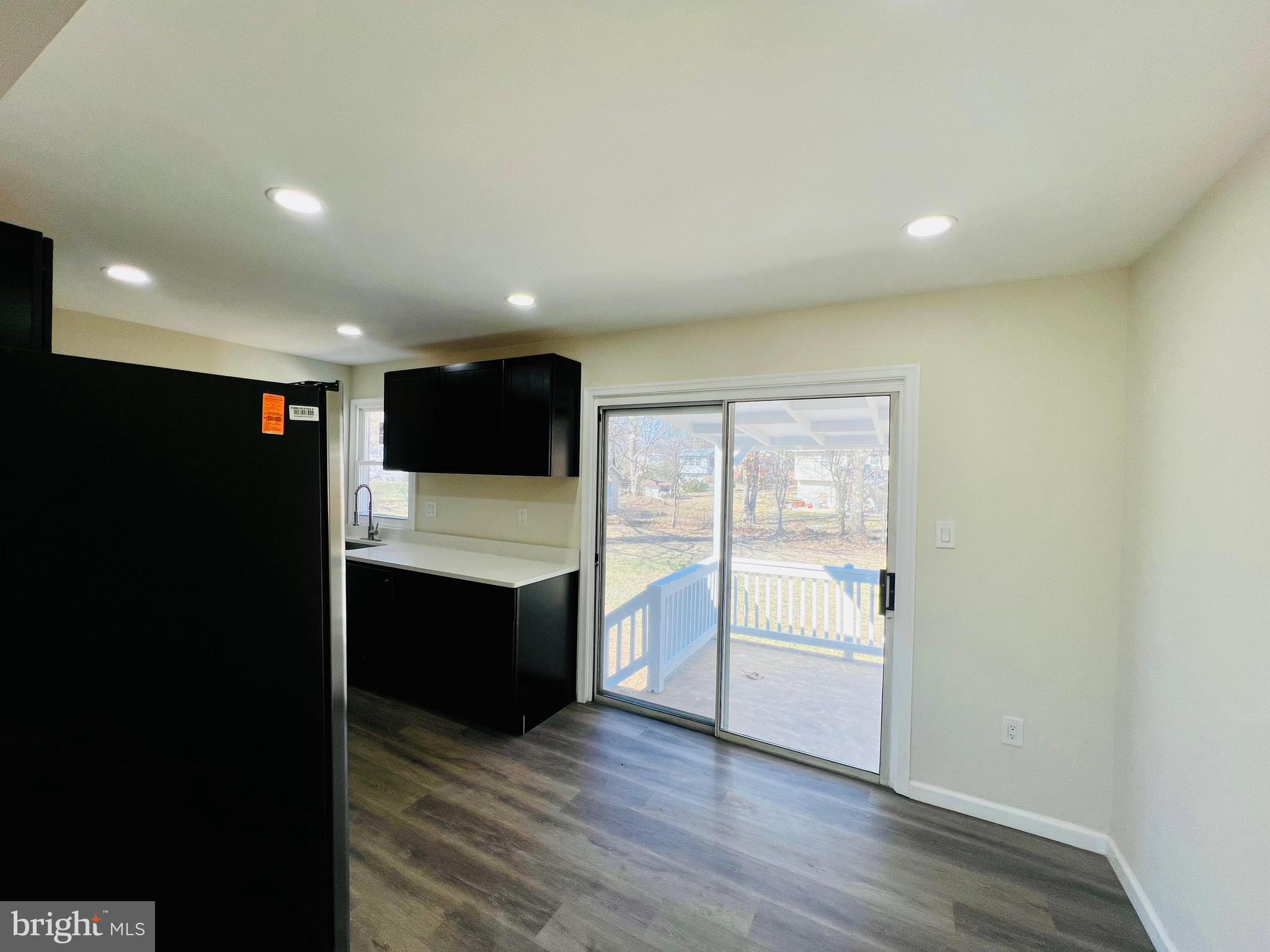 9826 Lomond Drive Manassas, VA 20109 - Photo 7 of 78 a view of an empty room with wooden floor and windows