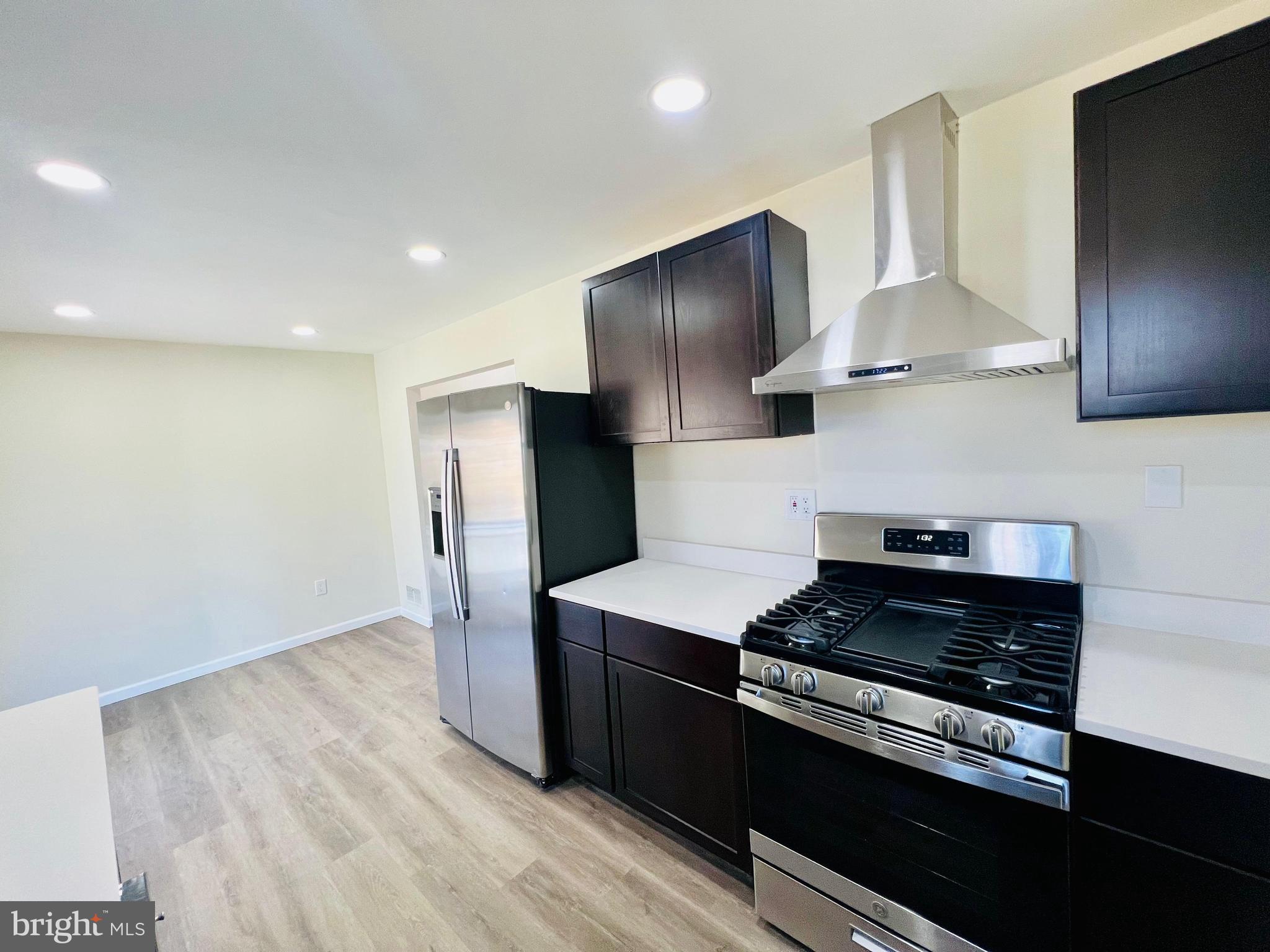 9826 Lomond Drive Manassas, VA 20109 - Photo 9 of 78 a kitchen with stainless steel appliances granite countertop a stove a refrigerator and a microwave