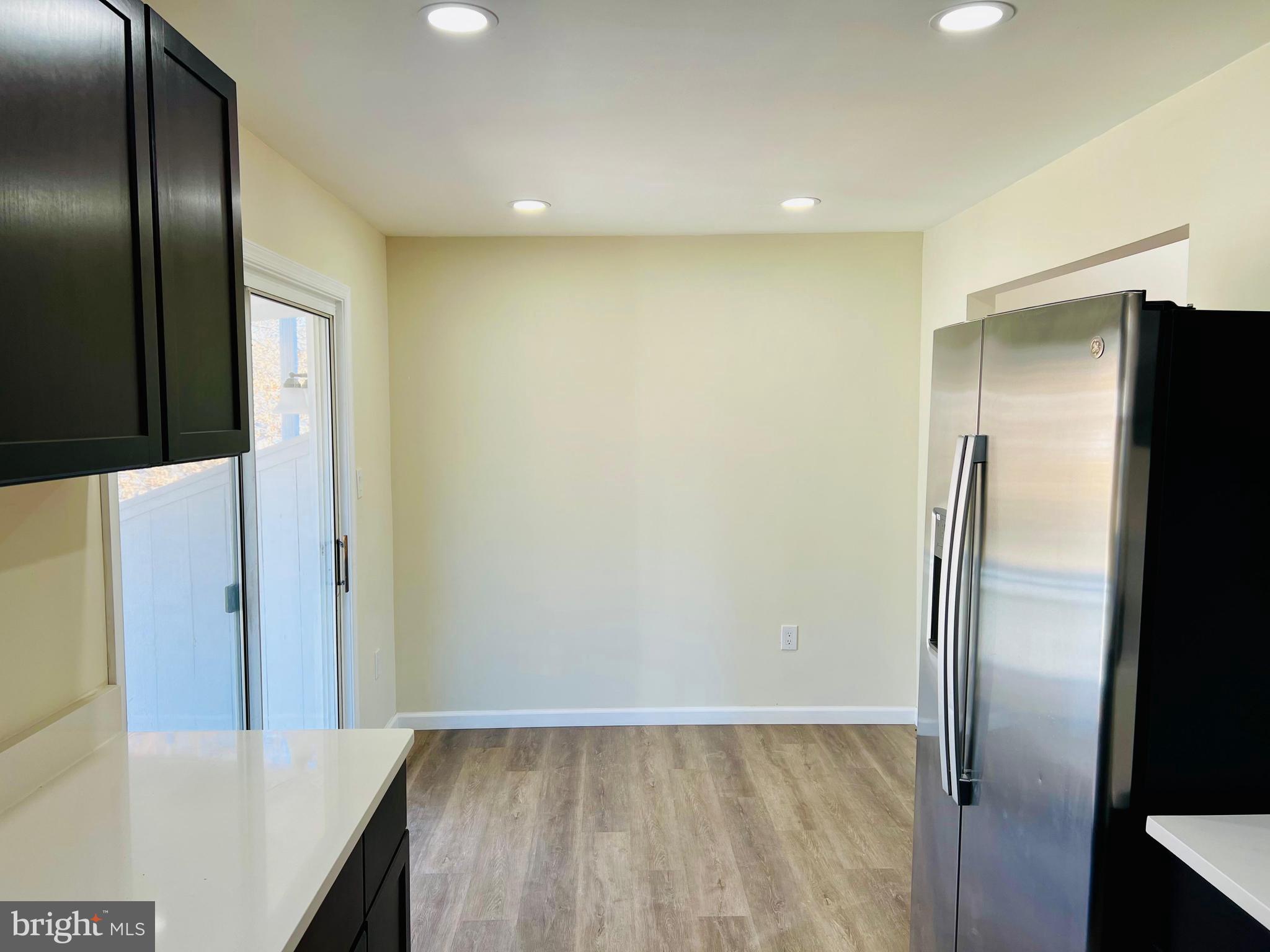 9826 Lomond Drive Manassas, VA 20109 - Photo 10 of 78 a view of hallway with a large window and stainless steel appliances