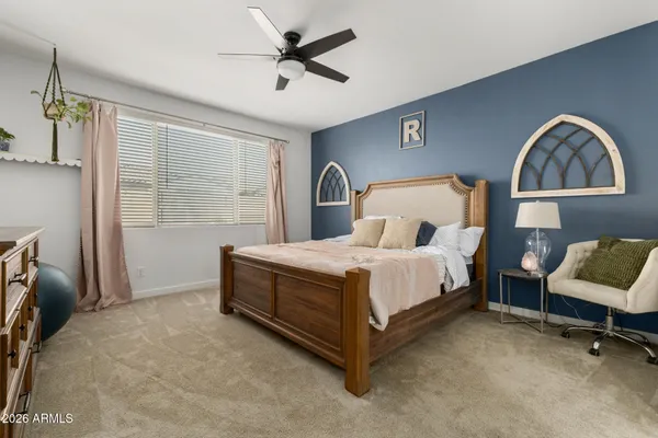 a spacious bedroom with a bed and a couch