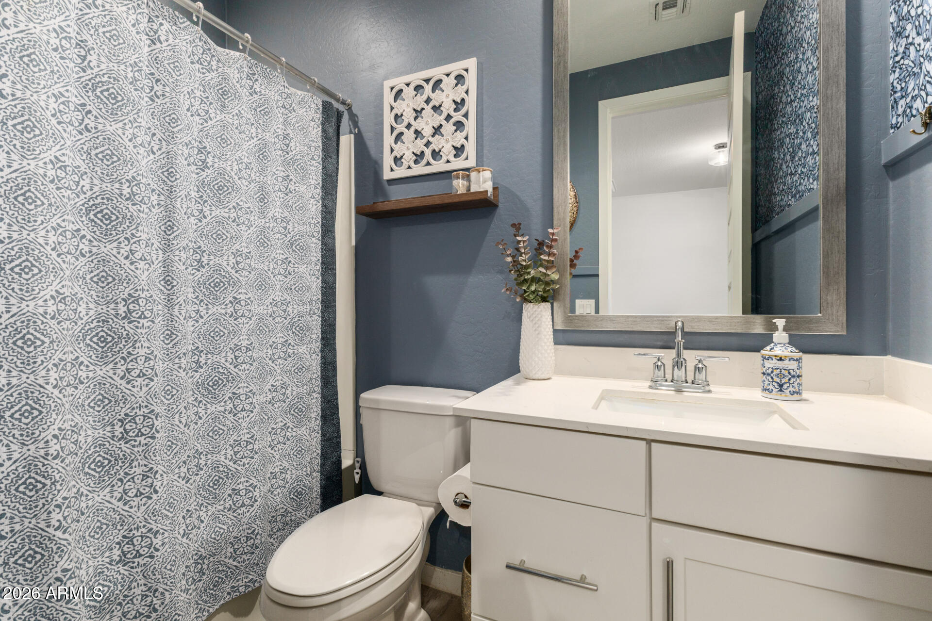 12560 East Ballentine Road Gold Canyon, AZ 85118 - Photo 28 of 35 a bathroom with a toilet sink and mirror