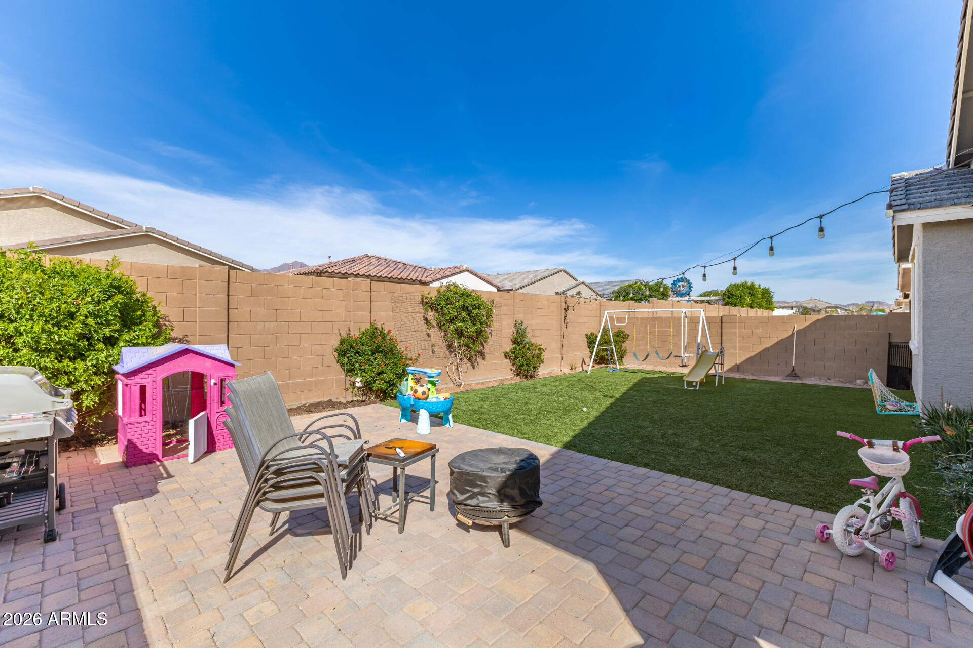 12560 East Ballentine Road Gold Canyon, AZ 85118 - Photo 31 of 35 a view of a patio with a table and chairs under an umbrella
