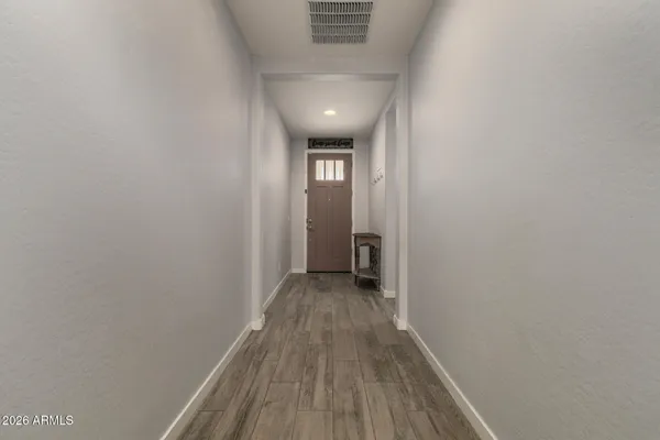 a view of a hallway with wooden floor