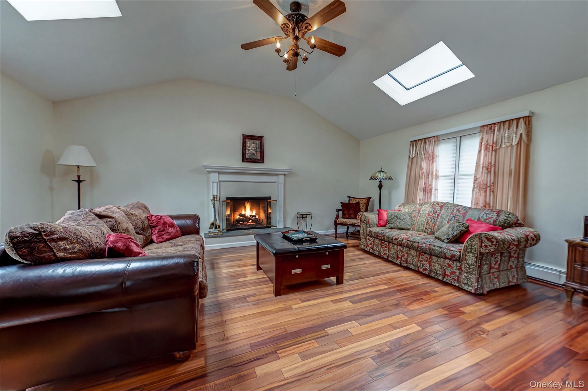 114 Randall Road Ridge, NY 11961 - Photo 12 of 48 a living room with furniture and a fireplace