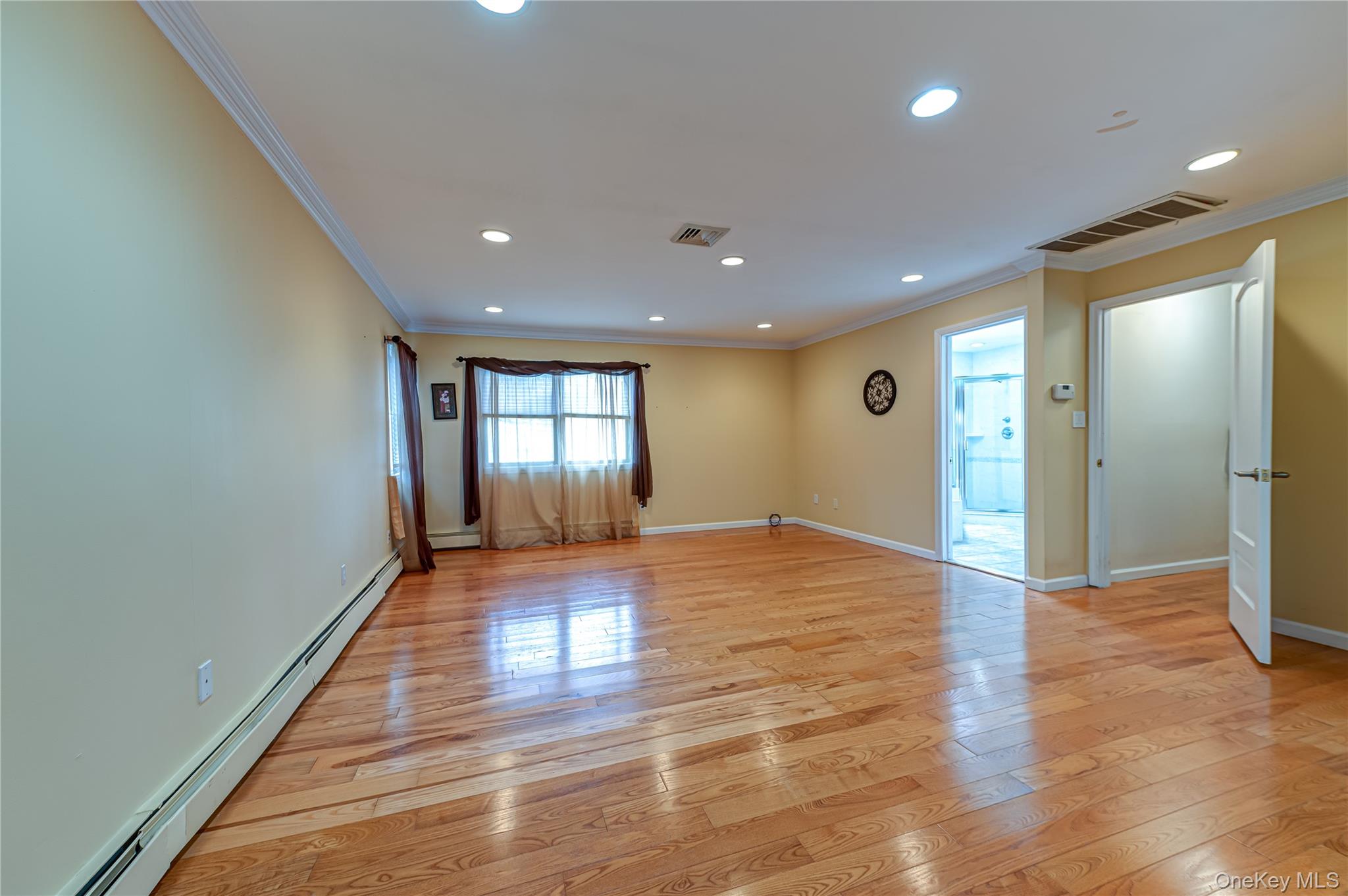 114 Randall Road Ridge, NY 11961 - Photo 29 of 48 a view of an empty room with window and wooden floor