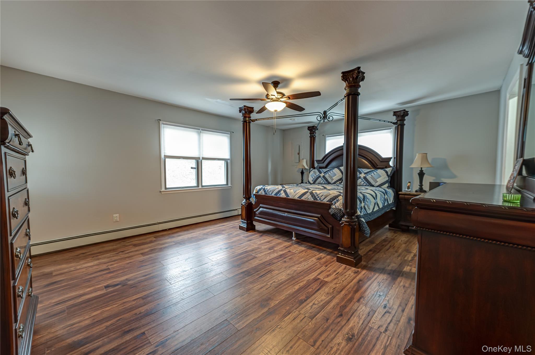 114 Randall Road Ridge, NY 11961 - Photo 30 of 48 a living room with couches and a fireplace with wooden floor