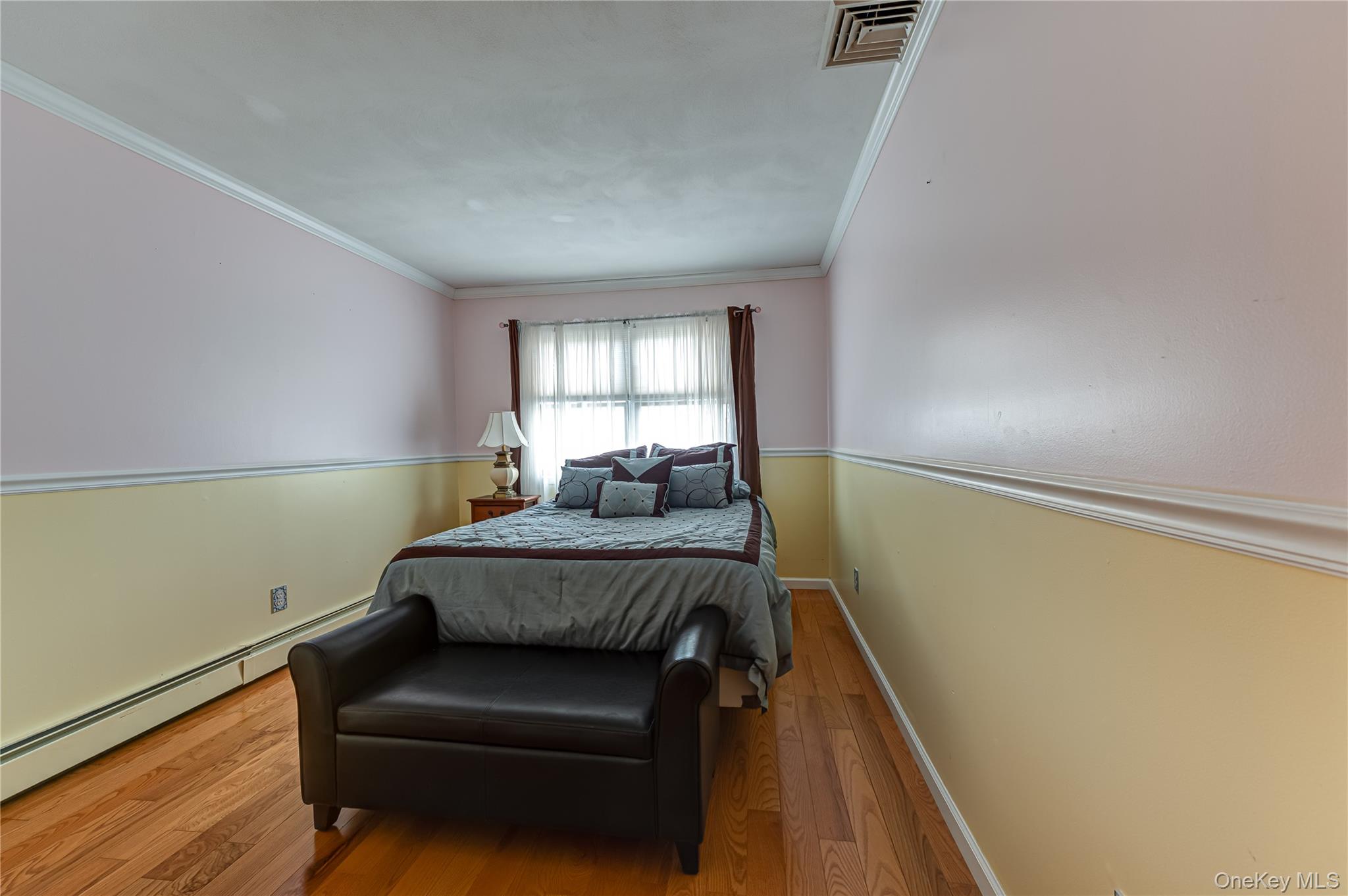 114 Randall Road Ridge, NY 11961 - Photo 32 of 48 a bedroom with bed and window