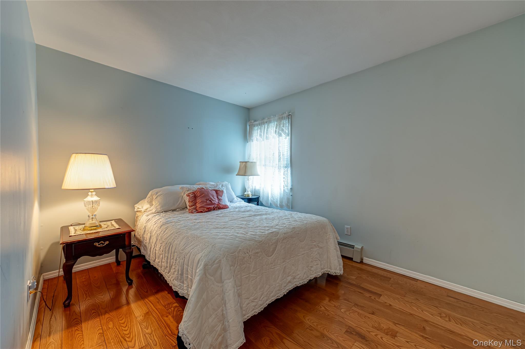 114 Randall Road Ridge, NY 11961 - Photo 33 of 48 a bedroom with a bed table and a window