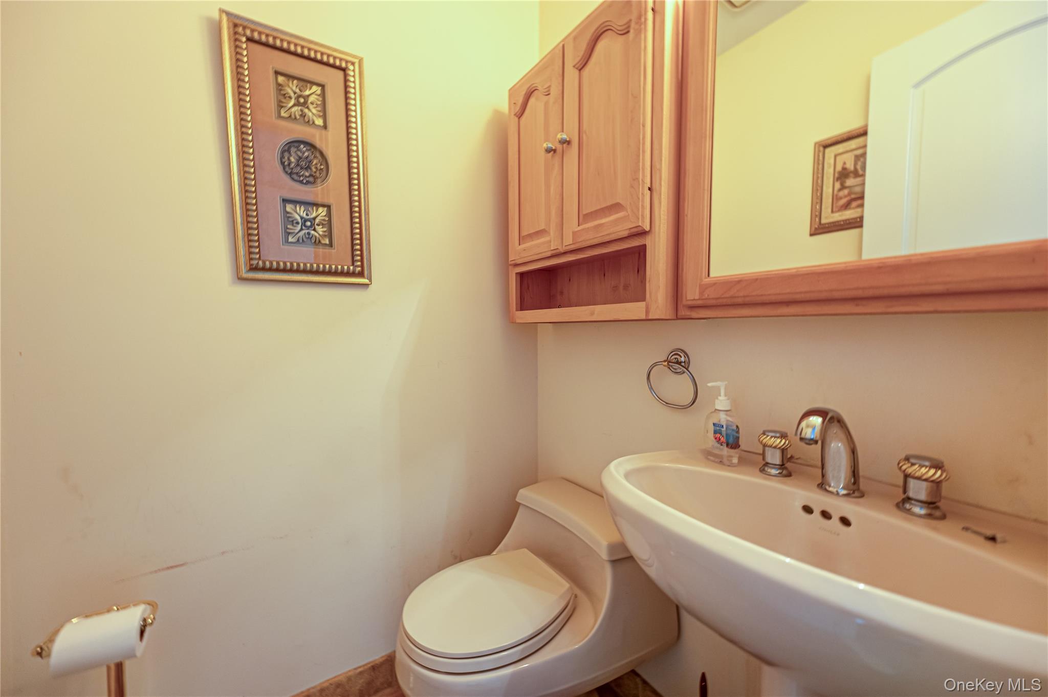114 Randall Road Ridge, NY 11961 - Photo 35 of 48 a bathroom with a toilet sink and mirror