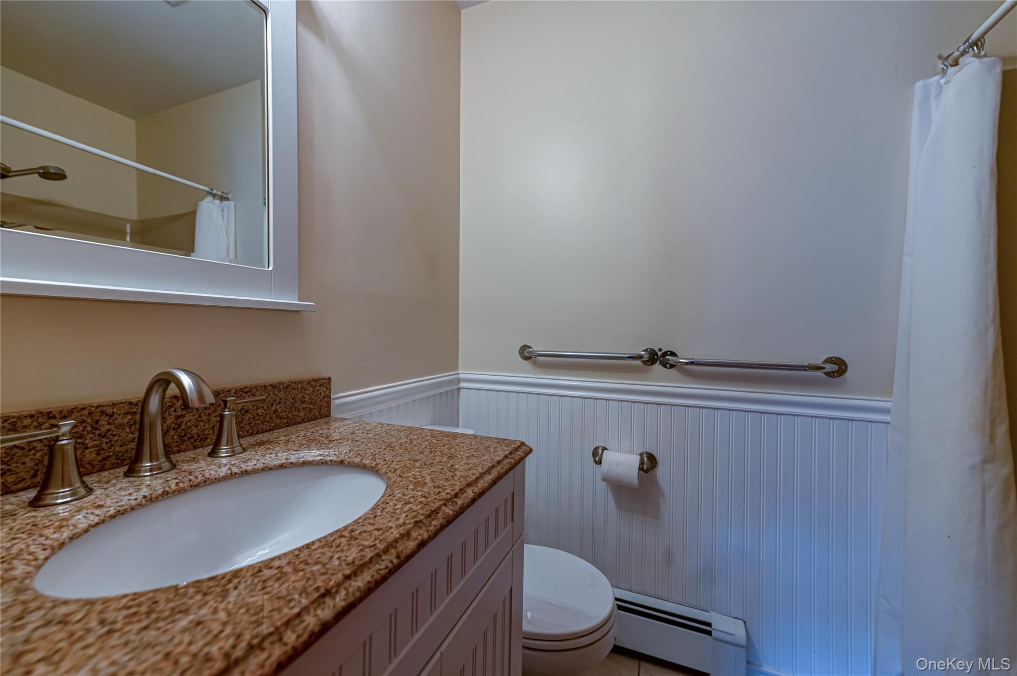 114 Randall Road Ridge, NY 11961 - Photo 36 of 48 a bathroom with a granite countertop sink a toilet and mirror