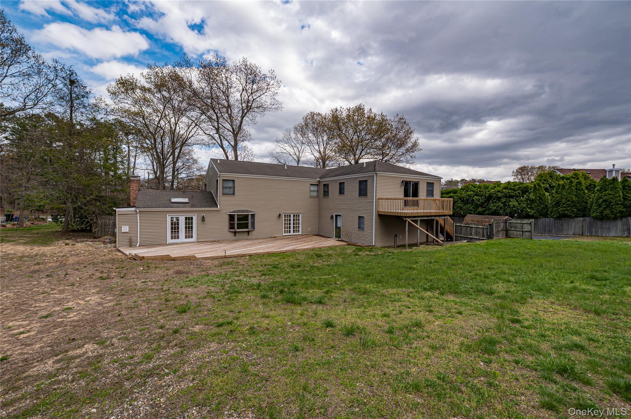 114 Randall Road Ridge, NY 11961 - Photo 41 of 48 a view of a house with a big yard and large trees