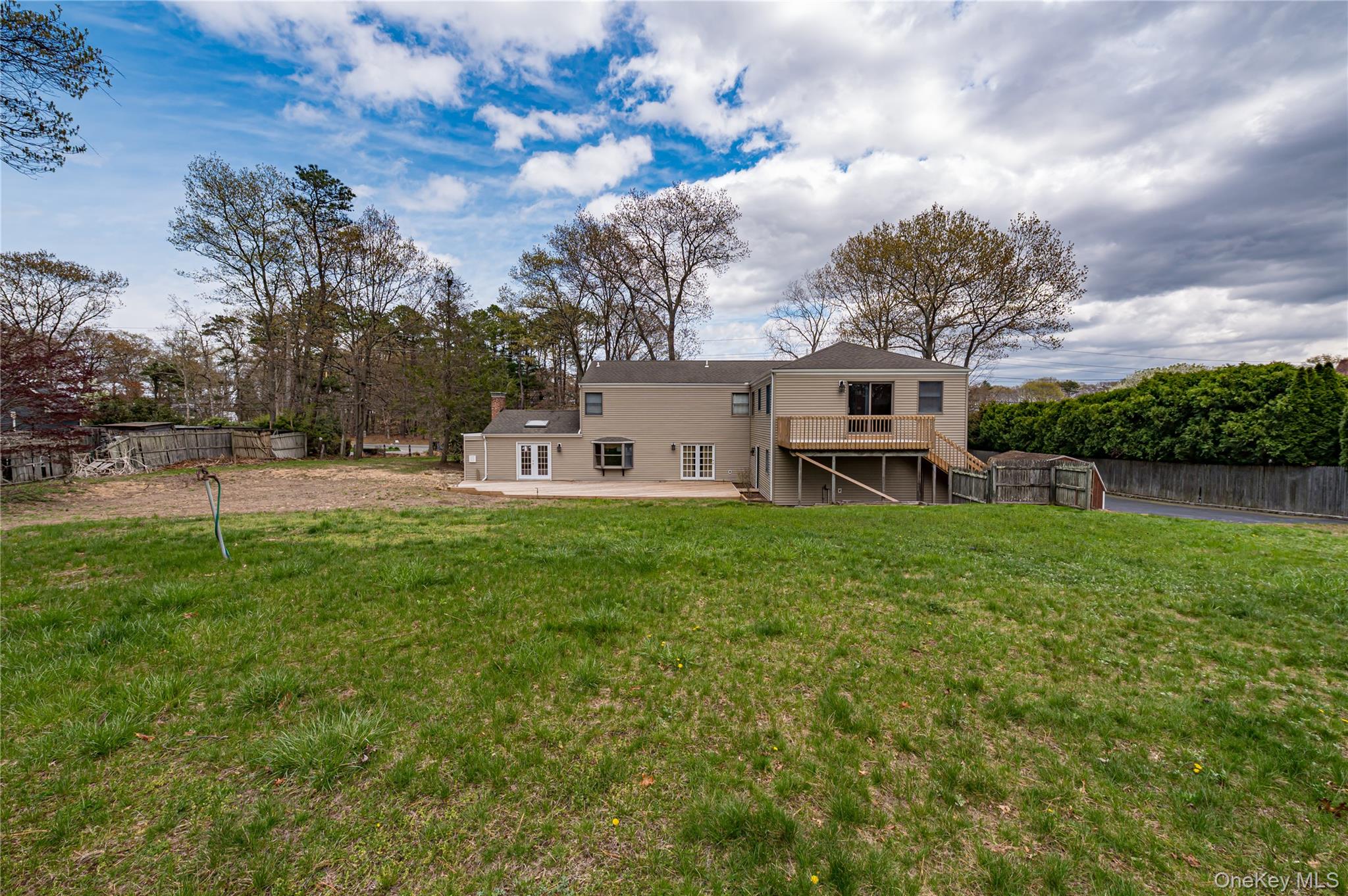 114 Randall Road Ridge, NY 11961 - Photo 44 of 48 a front view of a house with a big yard