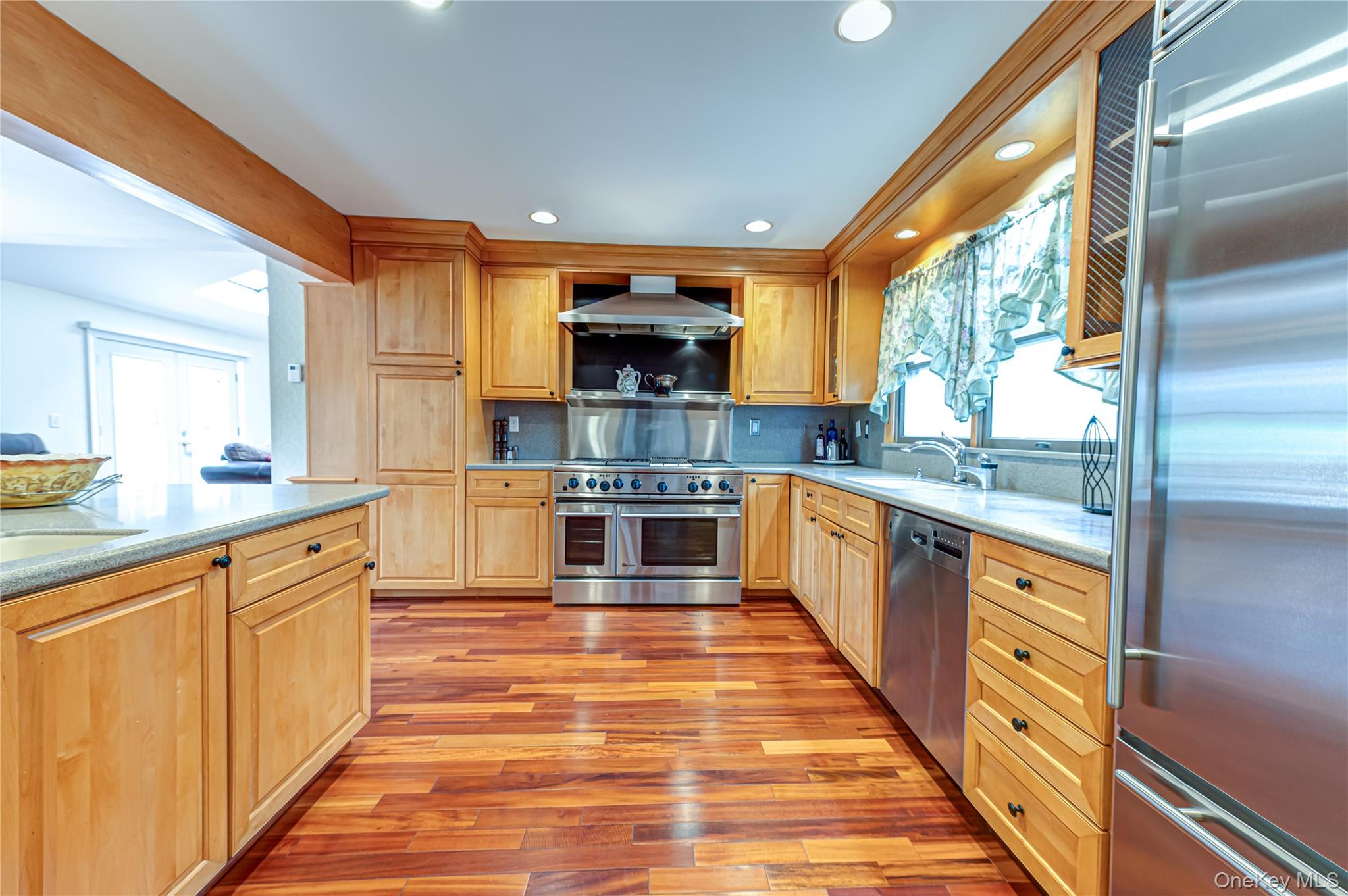 114 Randall Road Ridge, NY 11961 - Photo 6 of 48 a large kitchen with stainless steel appliances granite countertop a stove a sink and a refrigerator