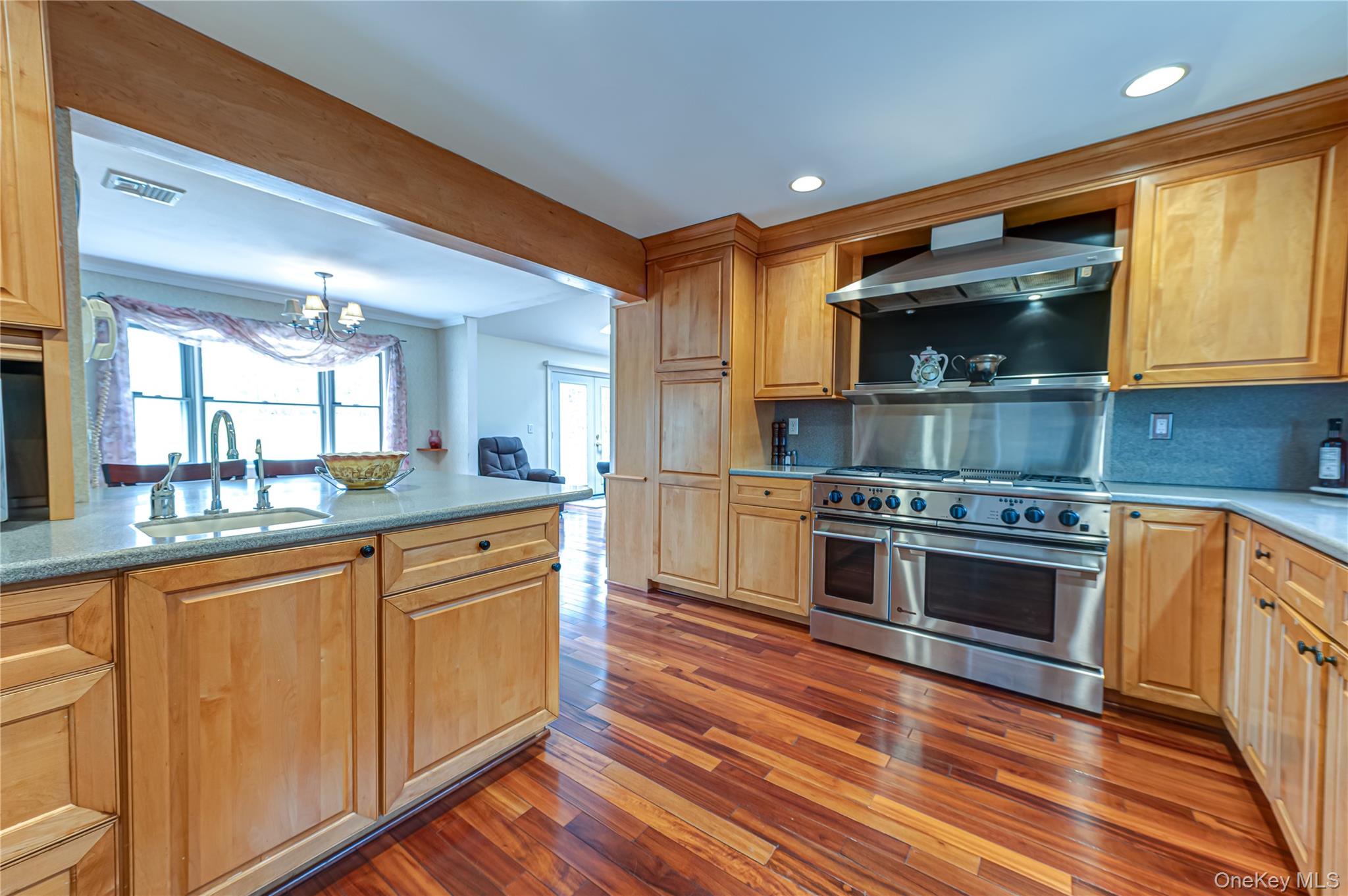 114 Randall Road Ridge, NY 11961 - Photo 7 of 48 a kitchen with stainless steel appliances kitchen island granite countertop a stove a sink and a refrigerator