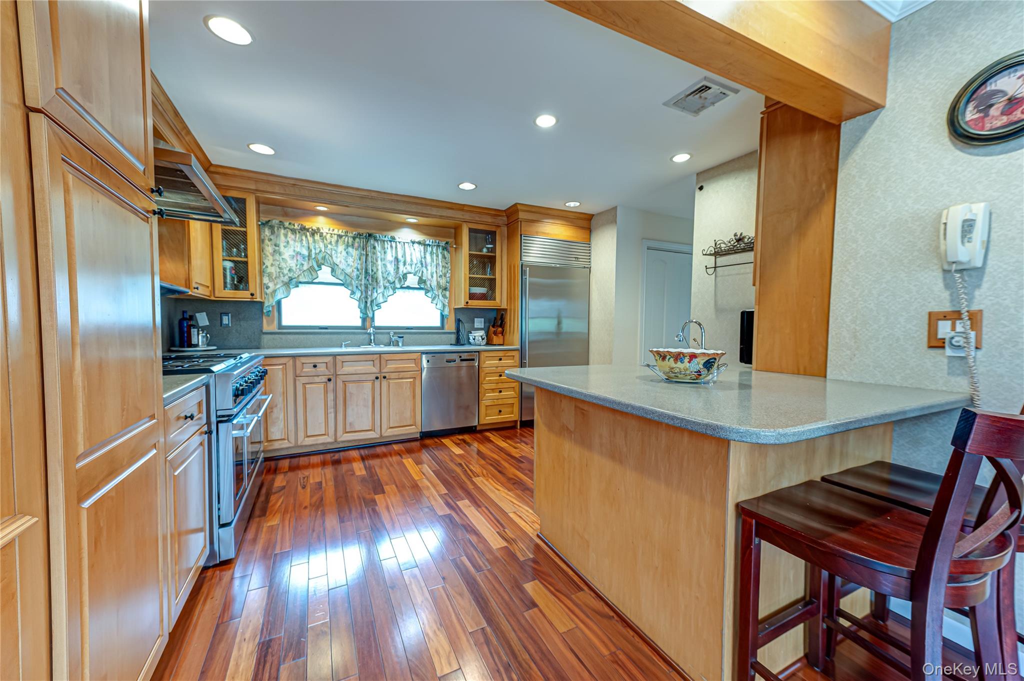 114 Randall Road Ridge, NY 11961 - Photo 8 of 48 a kitchen with stainless steel appliances granite countertop a sink and a refrigerator