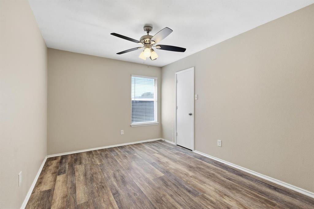 7733 Liz Lane Watauga, TX 76148 - Photo 22 of 27 Spare room featuring wood finished floors and ceiling fan