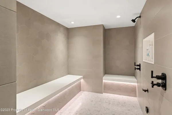 a bathroom with a bathtub and shower