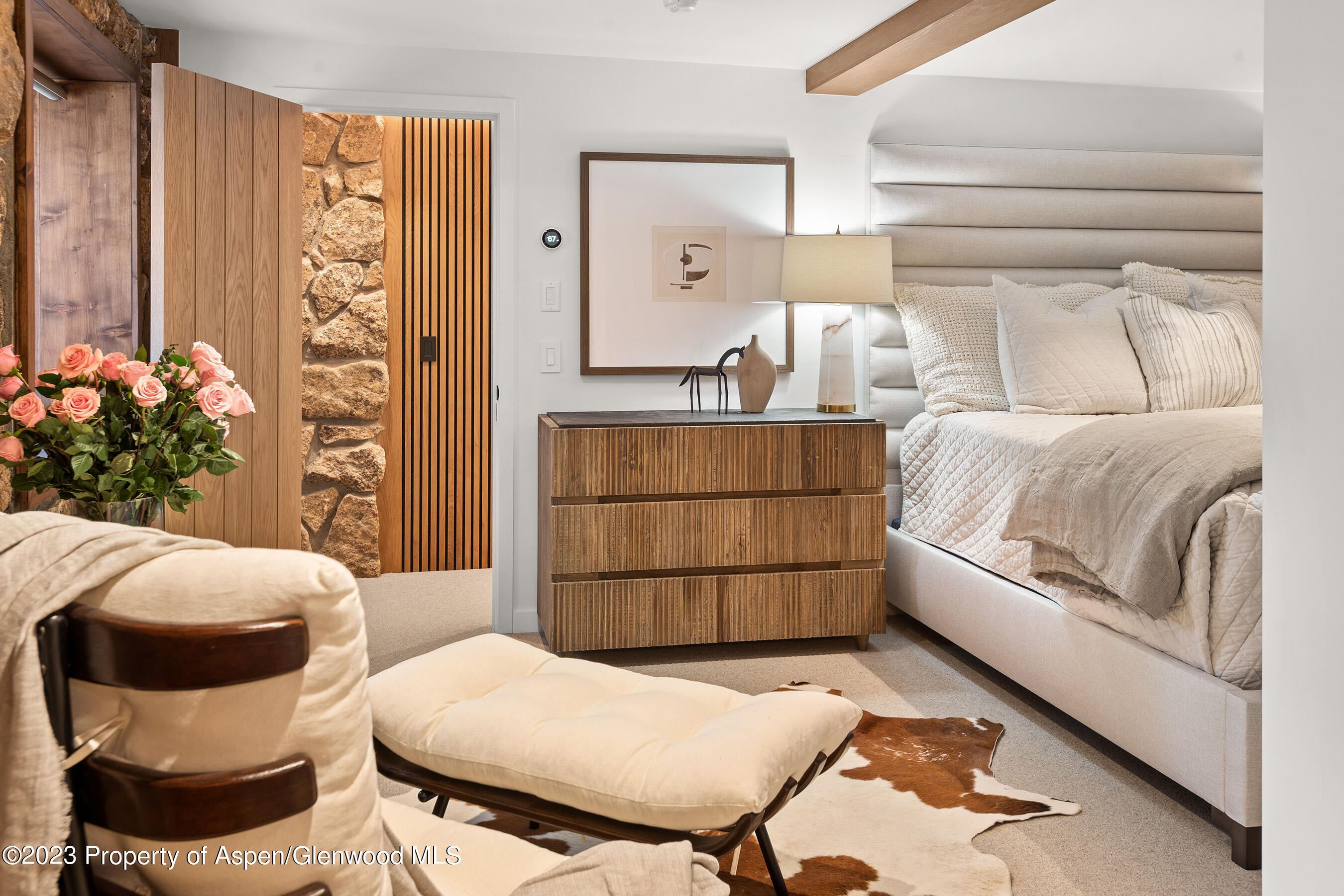 164 Eastwood Road Aspen, CO 81611 - Photo 17 of 42 a bedroom with a bed and wooden floor