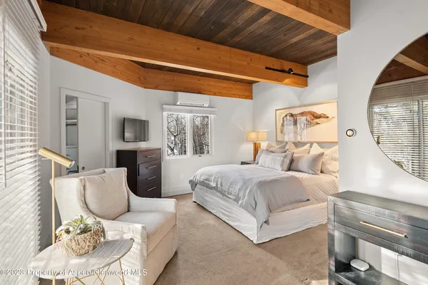a bedroom with furniture and a window