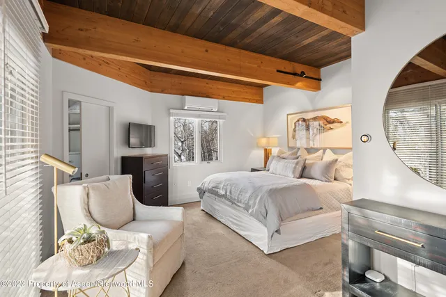 a bedroom with furniture and a window